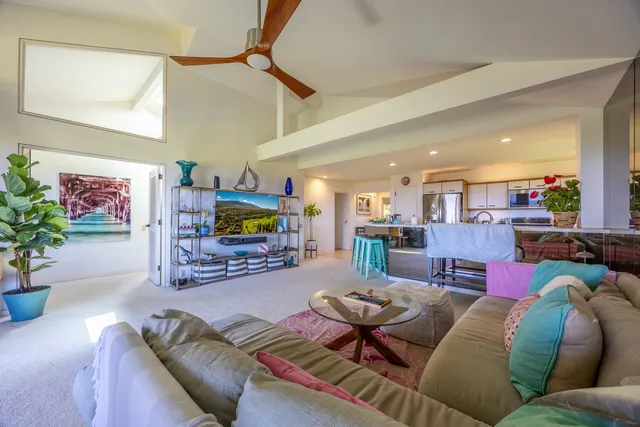 a large white bathroom with a granite countertop sink and a mirror