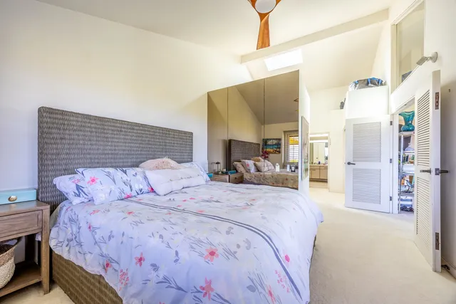 a view of a street sign under a large tree