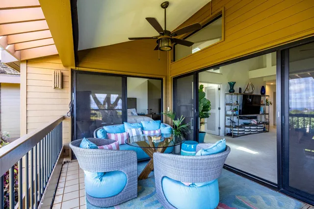 a living room with furniture kitchen view and a large window