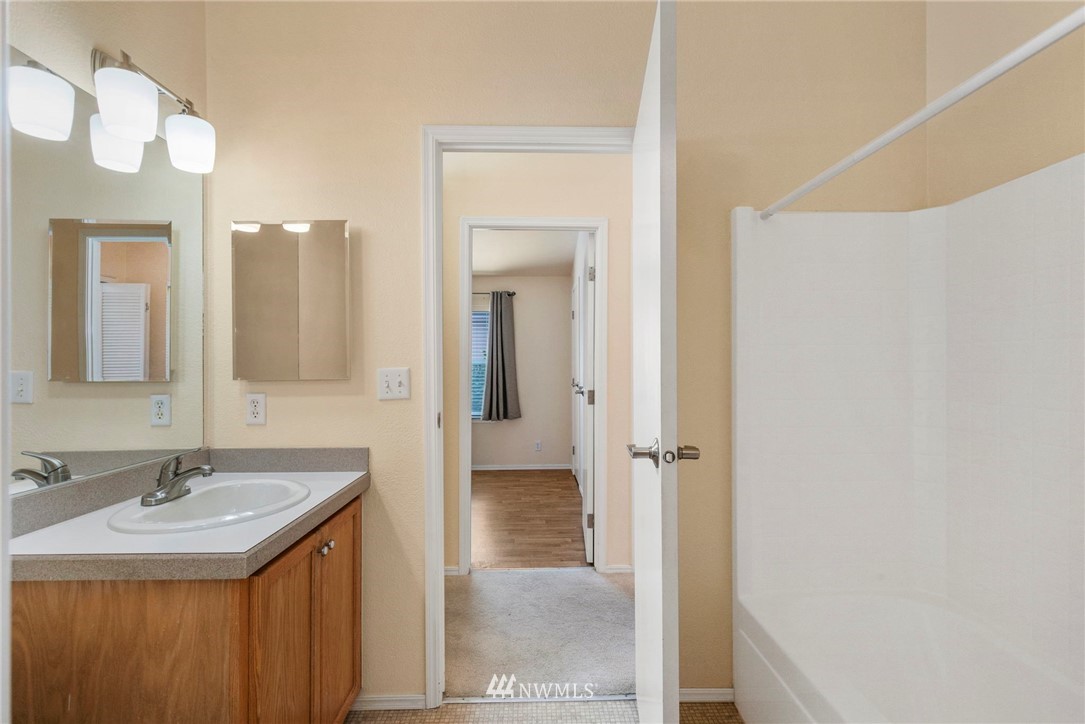 3532 Sylvan Pines Circle Bremerton, WA 98310 - Photo 15 of 22 a bathroom with a sink and a mirror