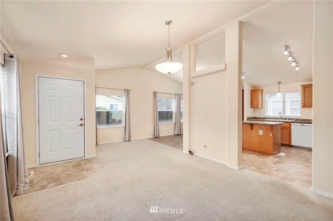 3532 Sylvan Pines Circle Bremerton, WA 98310 - Photo 9 of 22 a view of a kitchen with a refrigerator and a sink