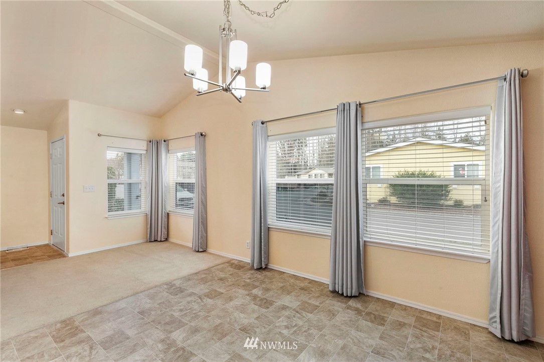 3532 Sylvan Pines Circle Bremerton, WA 98310 - Photo 10 of 22 a view of a livingroom with a chandelier fan and windows