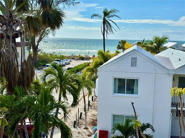 a front view of a house with a tree
