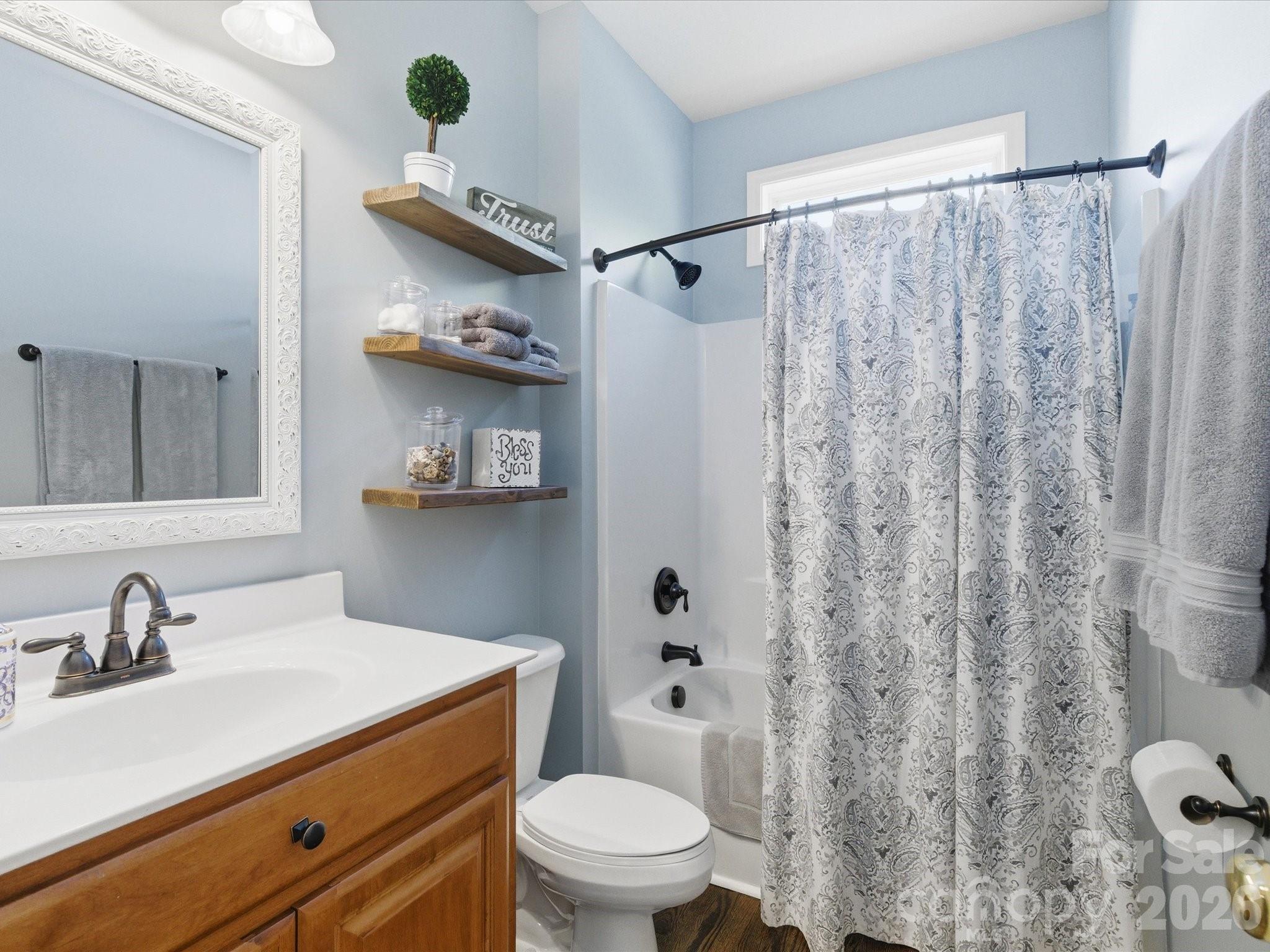 6318 Riverside Oaks Drive Huntersville, NC 28078 - Photo 12 of 48 a bathroom with a sink a toilet and a mirror