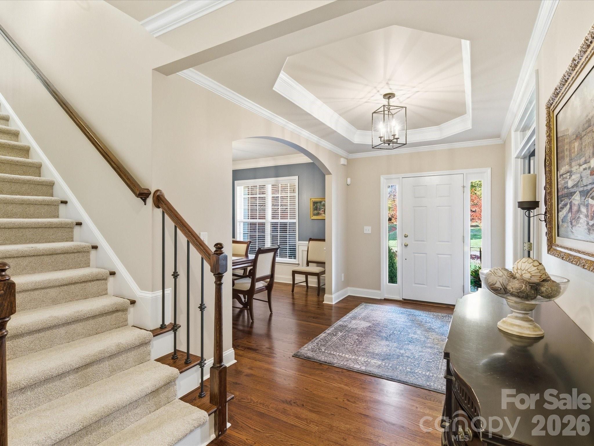 6318 Riverside Oaks Drive Huntersville, NC 28078 - Photo 24 of 48 a view of a livingroom with furniture chandelier and wooden floor