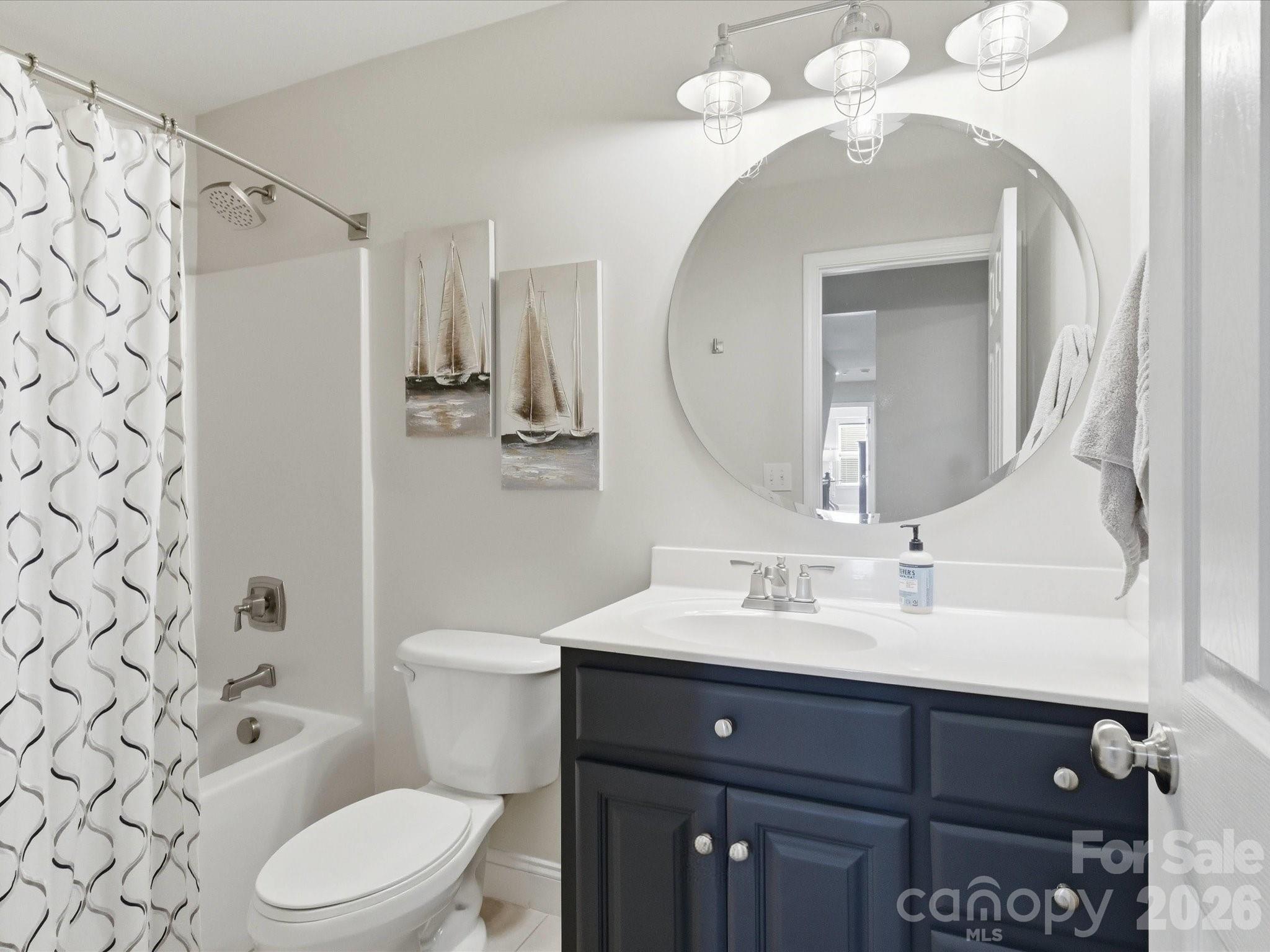 6318 Riverside Oaks Drive Huntersville, NC 28078 - Photo 29 of 48 a bathroom with a sink a toilet and a mirror