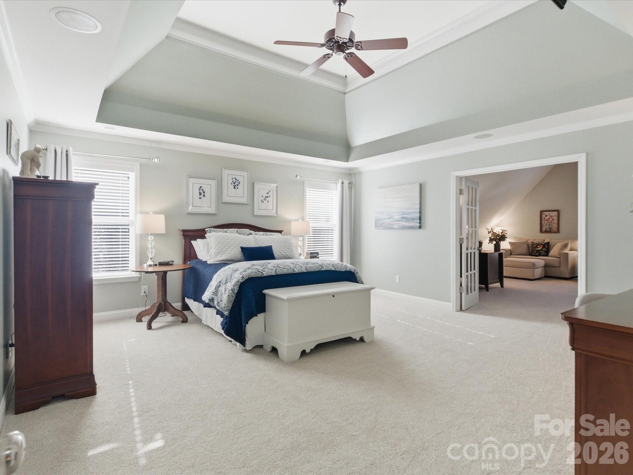 6318 Riverside Oaks Drive Huntersville, NC 28078 - Photo 31 of 48 a spacious bedroom with a bed and a chandelier