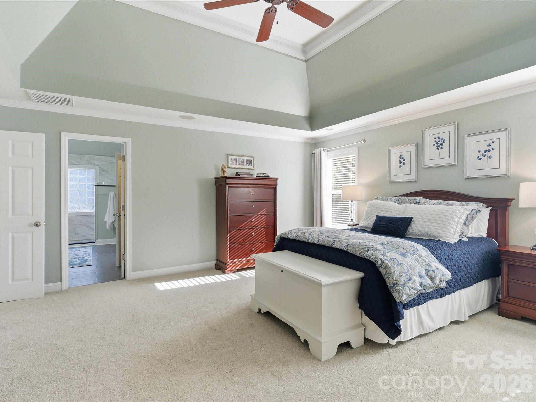 6318 Riverside Oaks Drive Huntersville, NC 28078 - Photo 33 of 48 a spacious bedroom with a bed and a lamp
