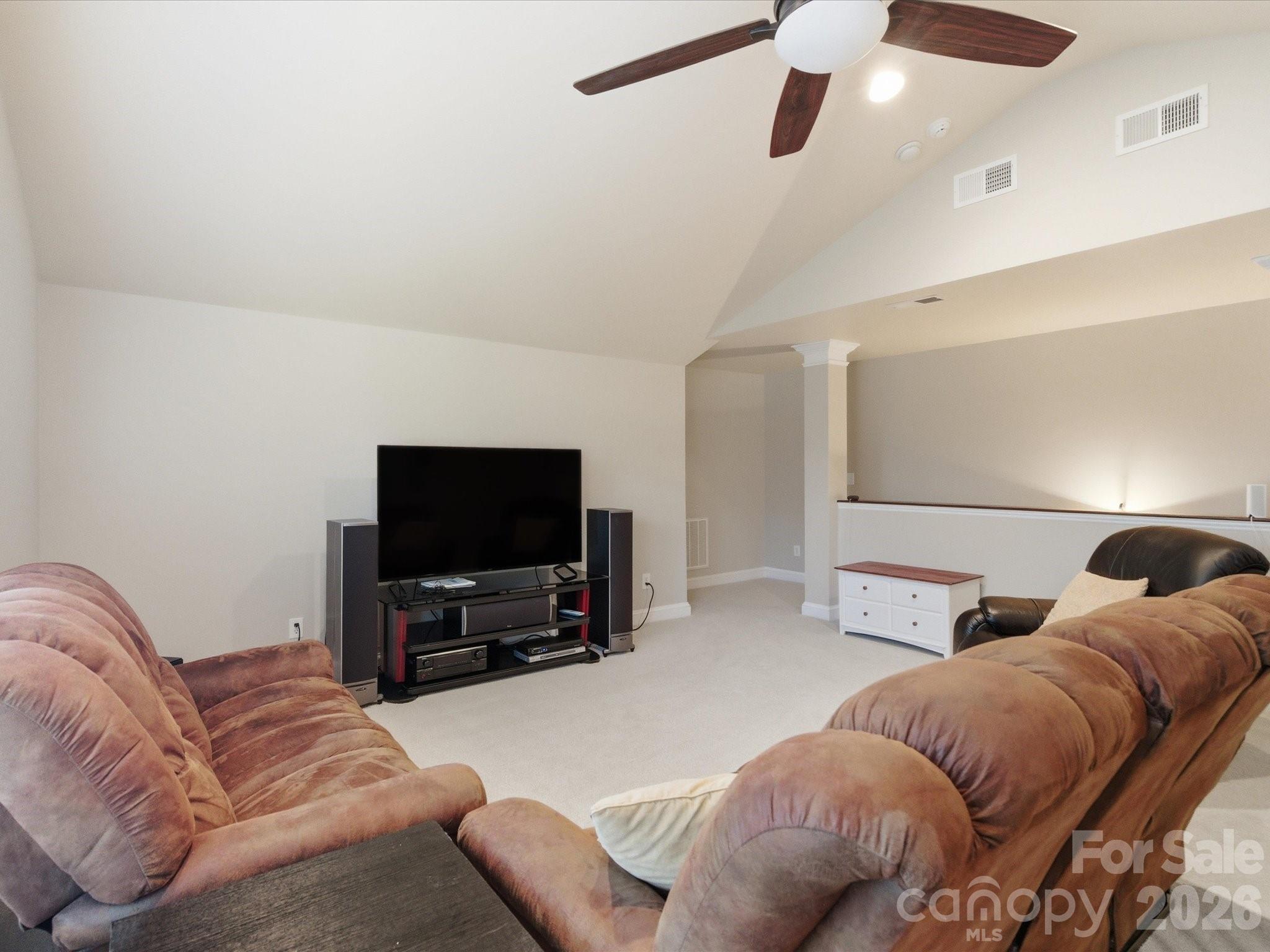 6318 Riverside Oaks Drive Huntersville, NC 28078 - Photo 41 of 48 a living room with a couch and a flat screen tv