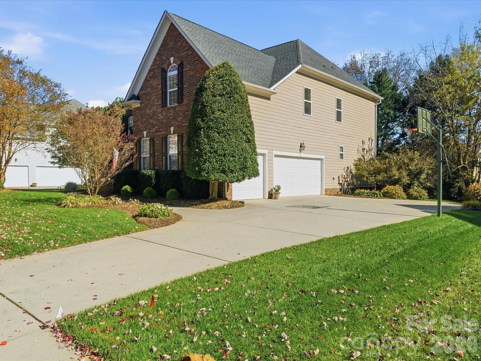 6318 Riverside Oaks Drive Huntersville, NC 28078 - Photo 42 of 48 a view of a white house next to a yard and trees