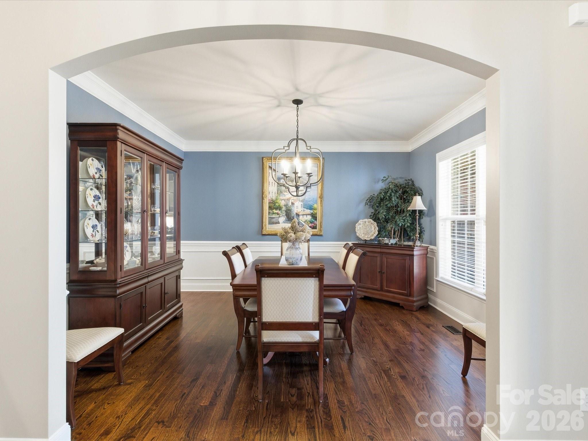 6318 Riverside Oaks Drive Huntersville, NC 28078 - Photo 6 of 48 a dining room with furniture a chandelier and wooden floor