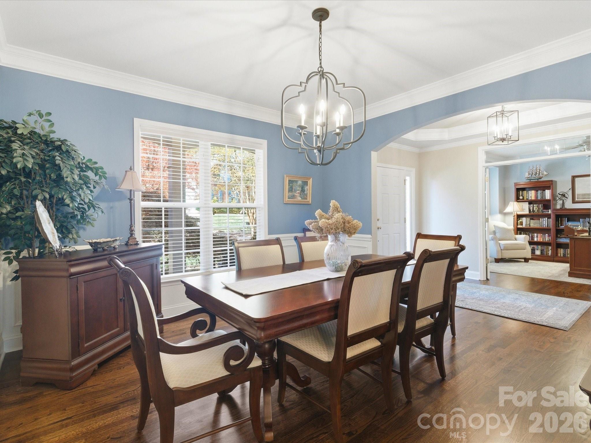 6318 Riverside Oaks Drive Huntersville, NC 28078 - Photo 7 of 48 a view of a dining room with furniture wooden floor and chandelier