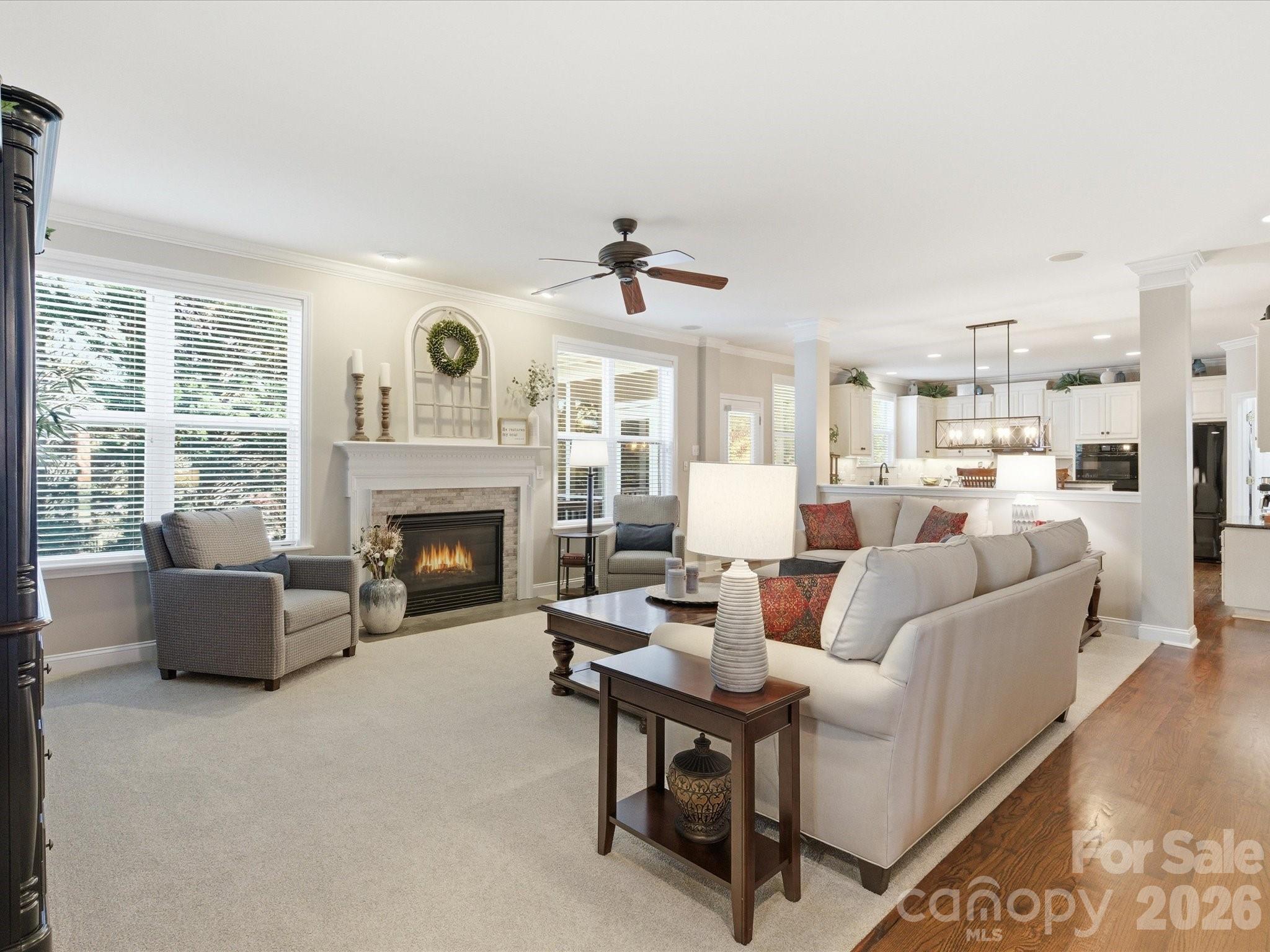 6318 Riverside Oaks Drive Huntersville, NC 28078 - Photo 10 of 48 a living room with furniture fireplace and a large window