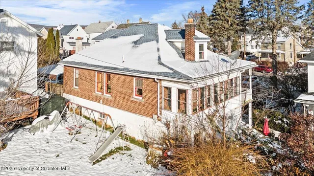 a view of a house with a snow on the road