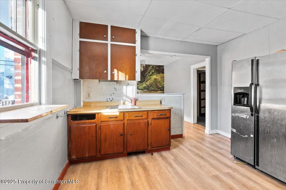 705 Landis Street Scranton, PA 18504 - Photo 13 of 35 a kitchen with stainless steel appliances granite countertop a sink and wooden cabinets