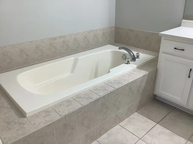 a white bath tub sitting in a bathroom