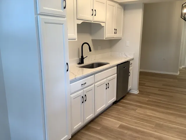 a kitchen with sink and cabinets