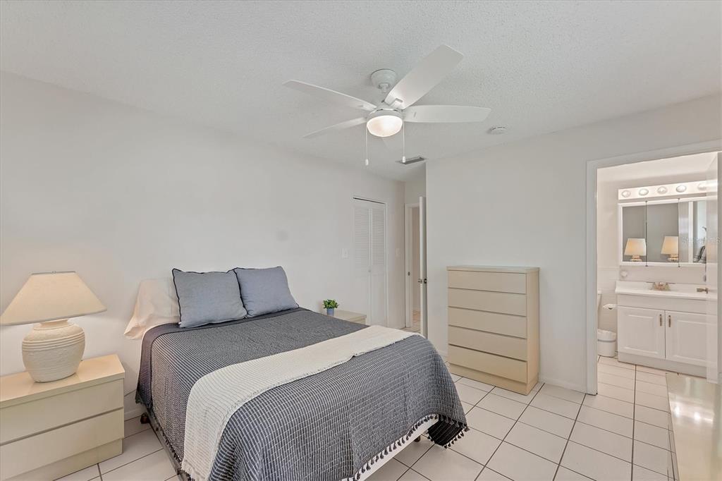 534 Sutton Place Longboat Key, FL 34228 - Photo 14 of 47 a bedroom with a bed and a cabinets
