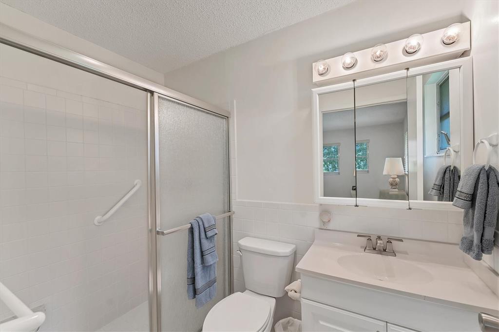 534 Sutton Place Longboat Key, FL 34228 - Photo 16 of 47 a bathroom with a sink a toilet and a mirror