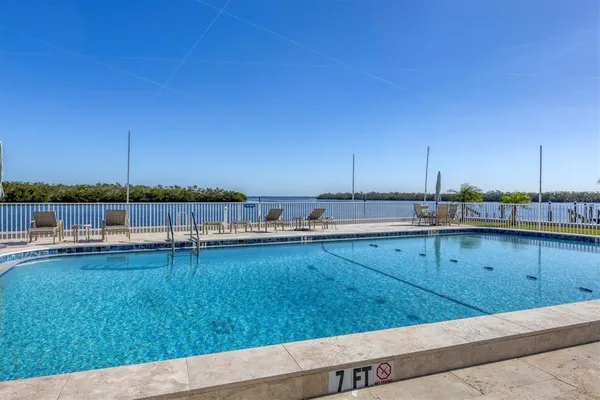 a view of a swimming pool and an outdoor seating