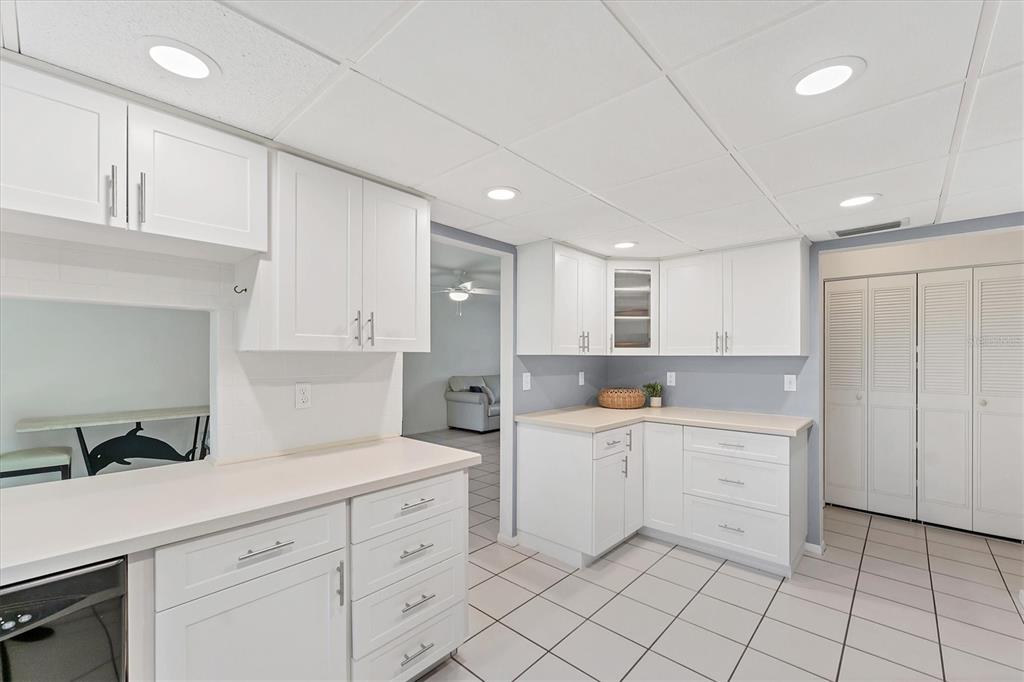 534 Sutton Place Longboat Key, FL 34228 - Photo 10 of 47 a kitchen with white cabinets and sink