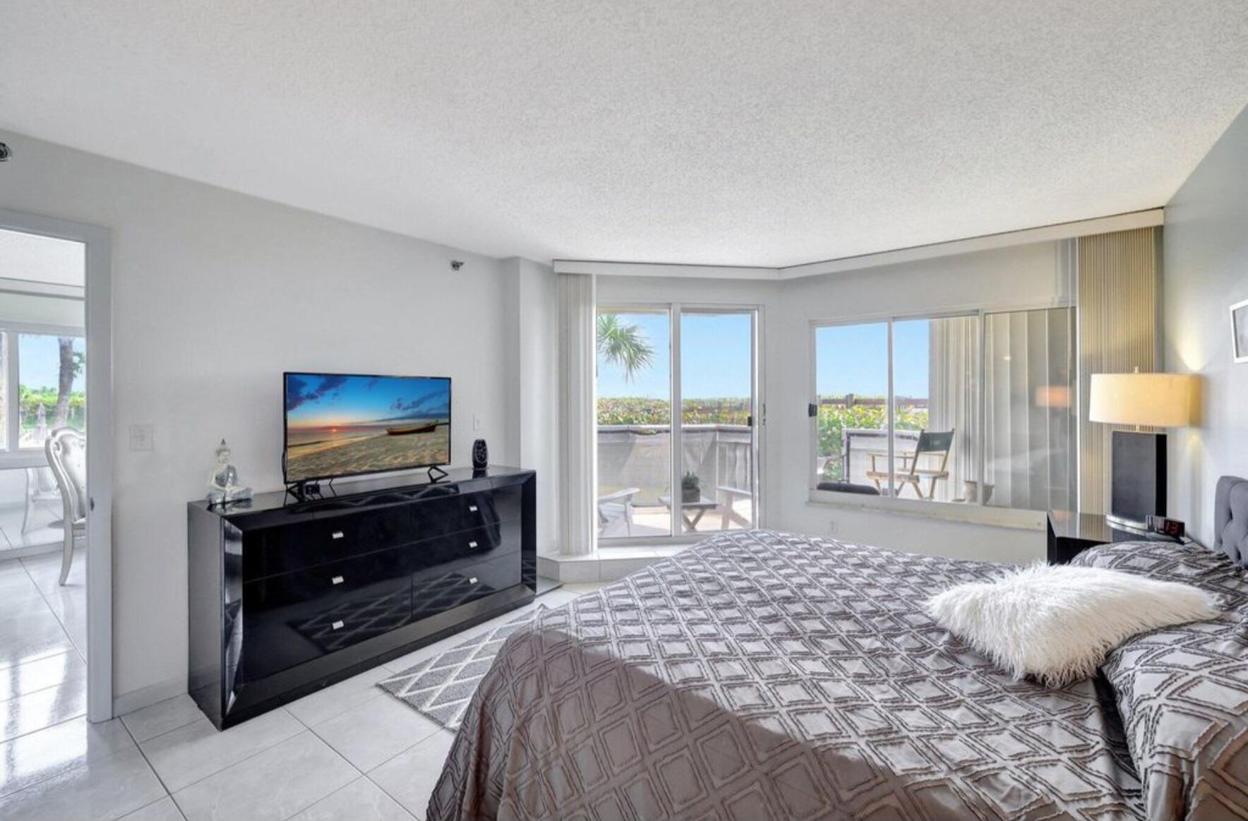 3870 North Hwy A1A, Unit 1011 Hutchinson Island, FL 34949 - Photo 11 of 30 a bedroom with a bed and a television