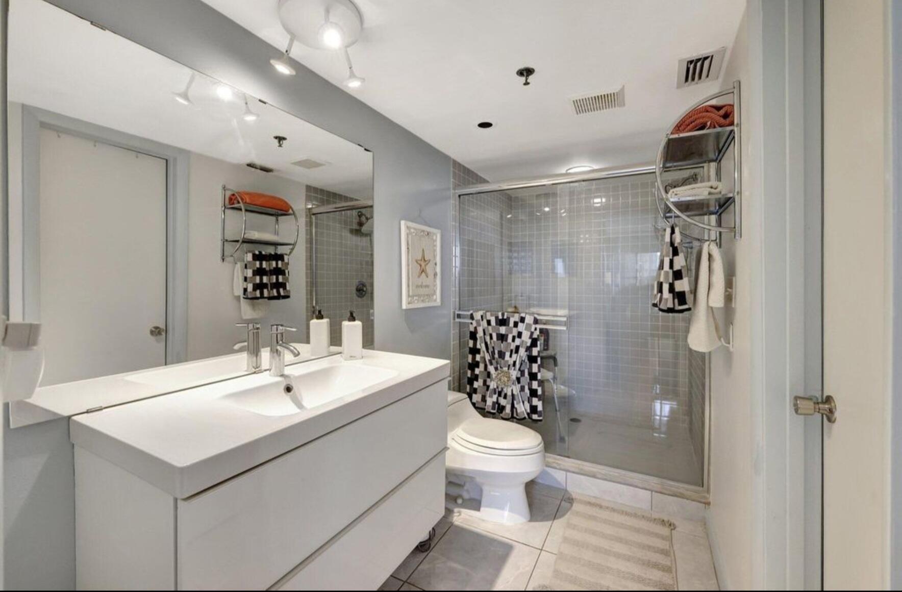 3870 North Hwy A1A, Unit 1011 Hutchinson Island, FL 34949 - Photo 15 of 30 a bathroom with a sink toilet and shower