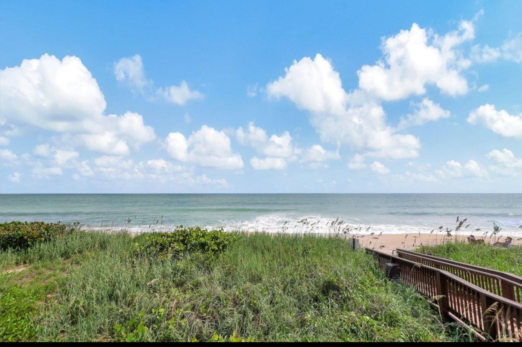 3870 North Hwy A1A, Unit 1011 Hutchinson Island, FL 34949 - Photo 23 of 30 a view of a lake and mountain in the back