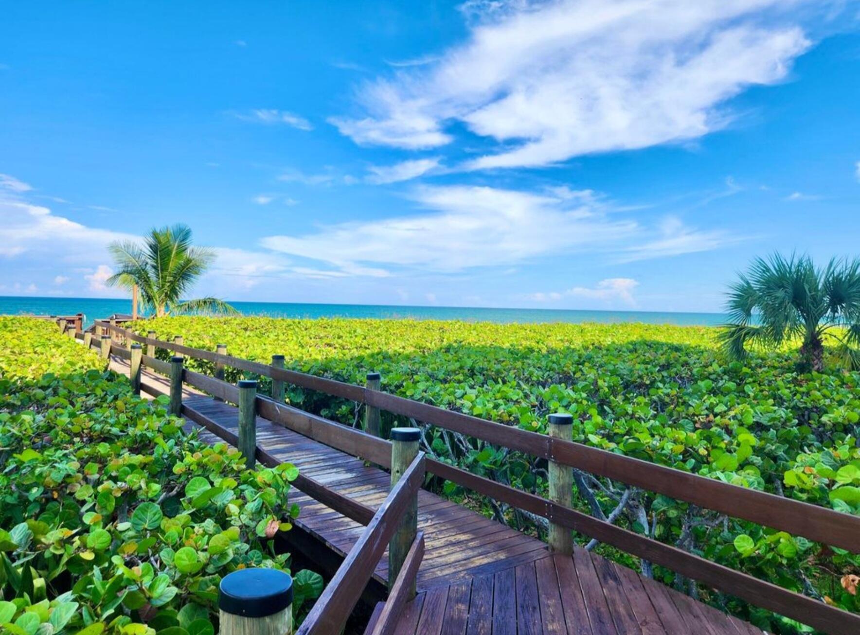 3870 North Hwy A1A, Unit 1011 Hutchinson Island, FL 34949 - Photo 24 of 30 a view of a balcony with wooden floor and outdoor space