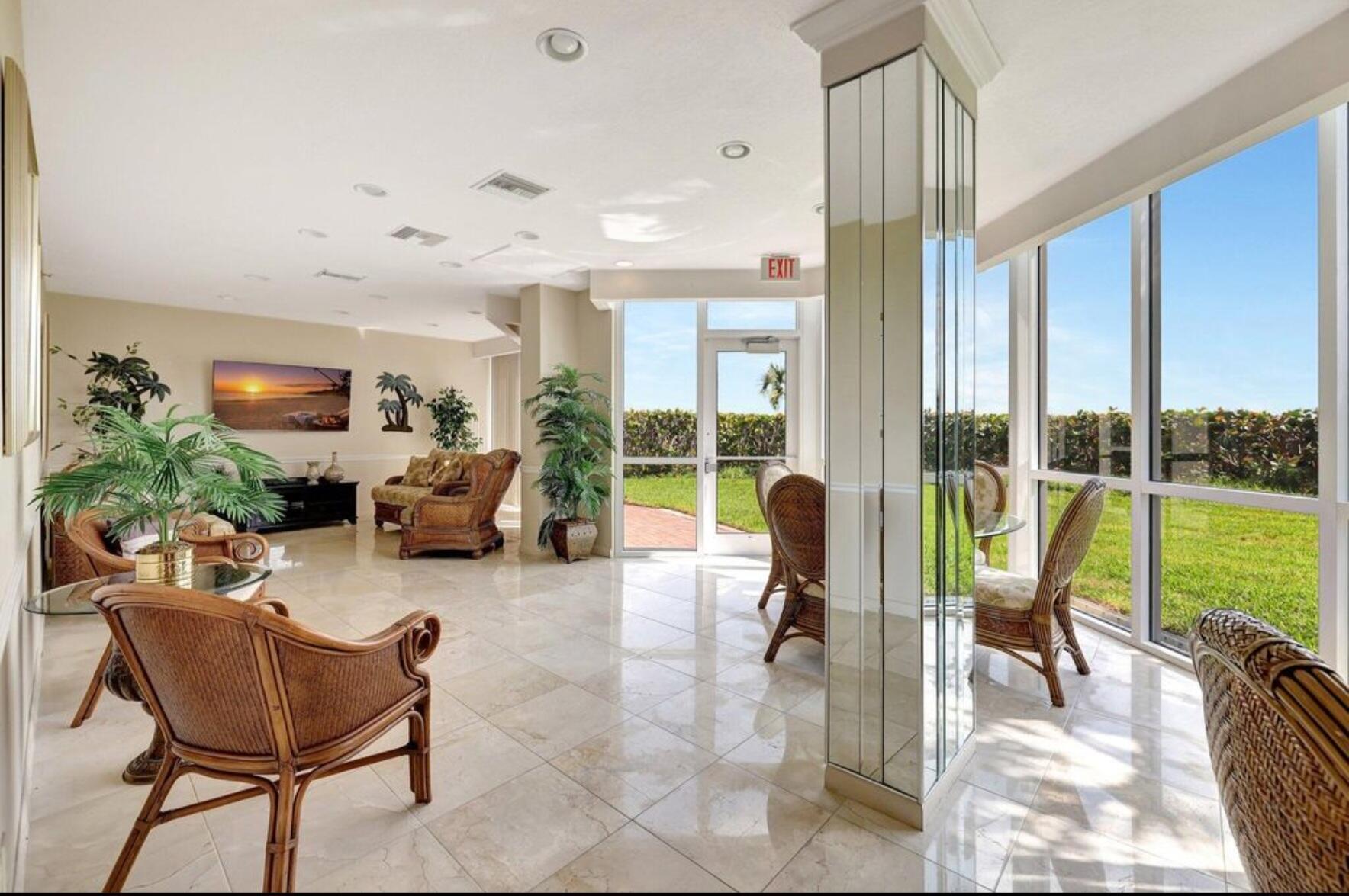 3870 North Hwy A1A, Unit 1011 Hutchinson Island, FL 34949 - Photo 28 of 30 a living room with furniture and a floor to ceiling window
