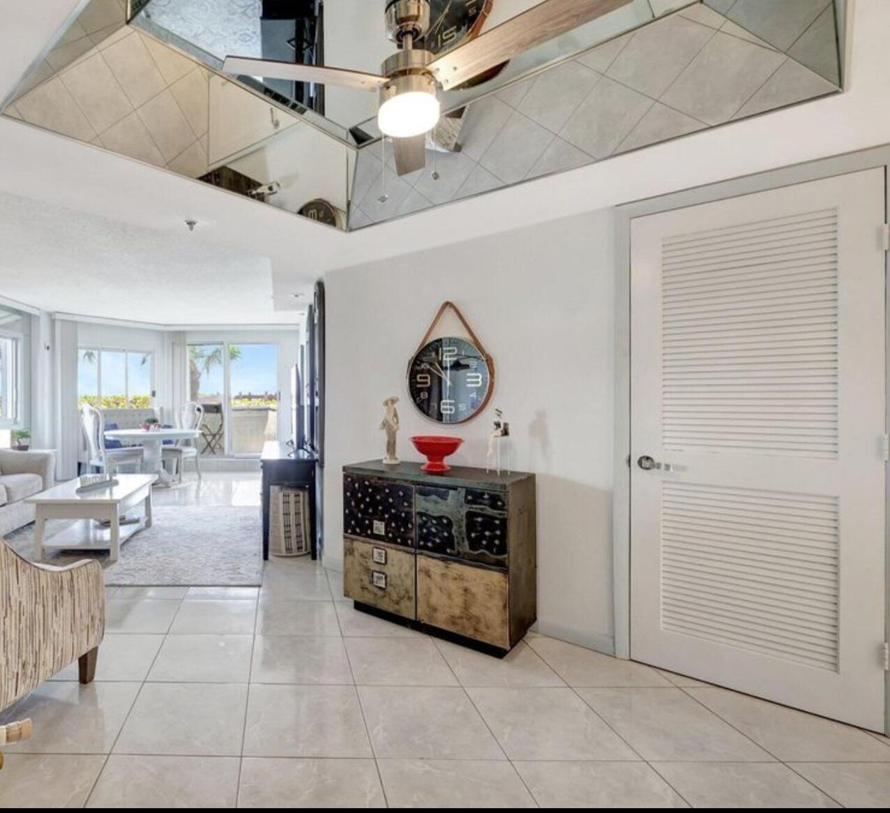3870 North Hwy A1A, Unit 1011 Hutchinson Island, FL 34949 - Photo 3 of 30 a living room with couches a dining table and with stainless steel appliances