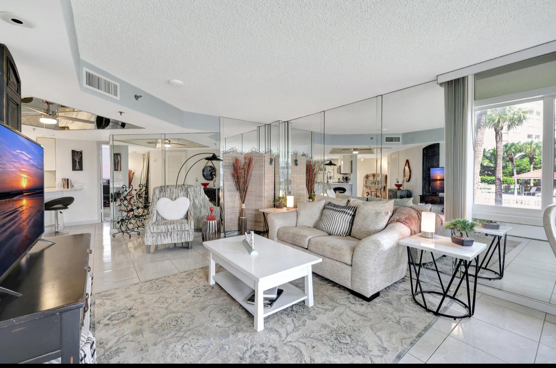 3870 North Hwy A1A, Unit 1011 Hutchinson Island, FL 34949 - Photo 8 of 30 a living room with furniture and a flat screen tv