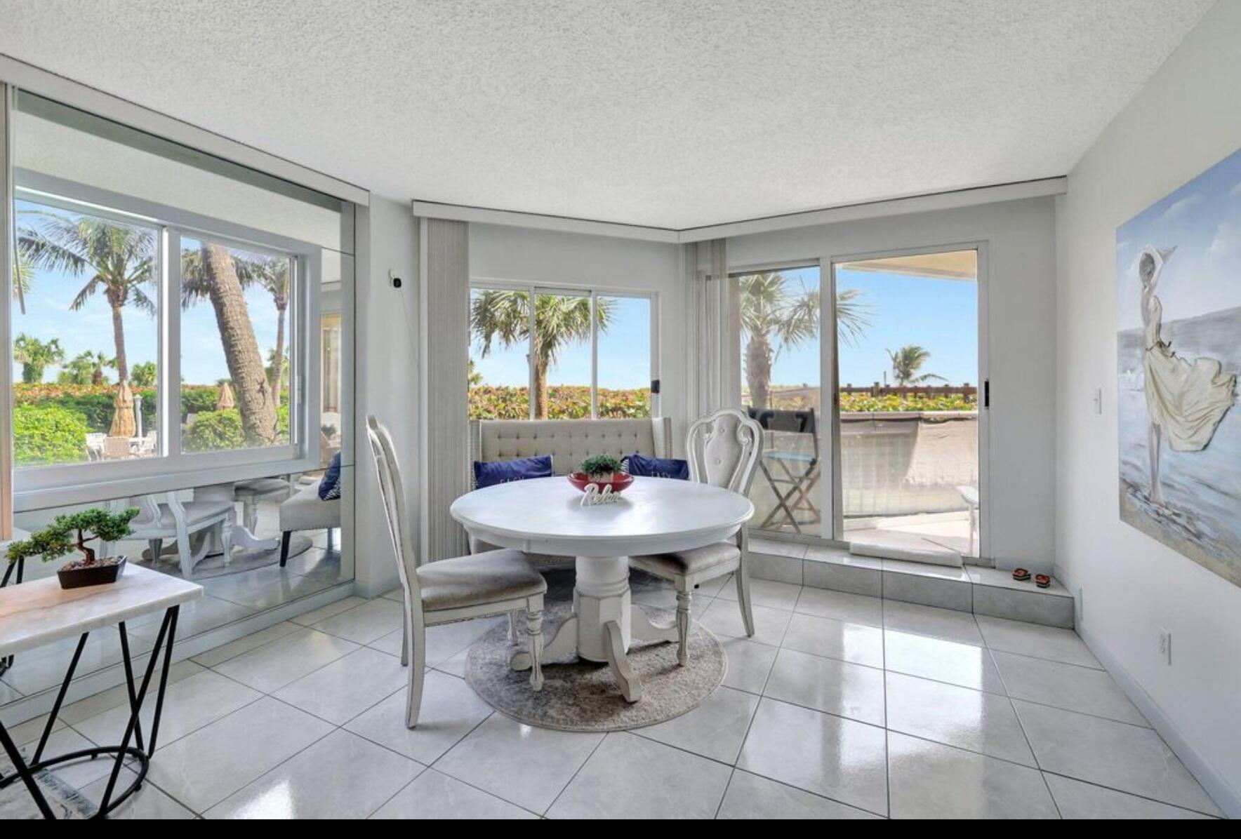 3870 North Hwy A1A, Unit 1011 Hutchinson Island, FL 34949 - Photo 9 of 30 a living room with furniture a window and a table