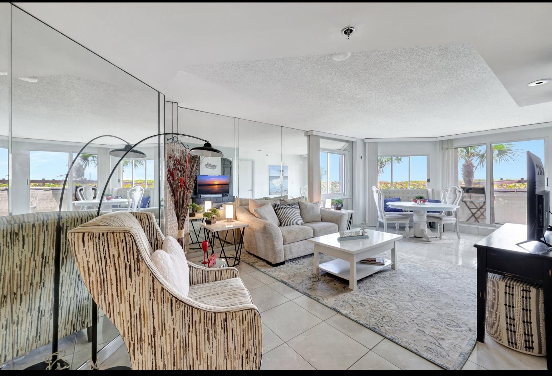3870 North Hwy A1A, Unit 1011 Hutchinson Island, FL 34949 - Photo 10 of 30 a living room with furniture and a flat screen tv