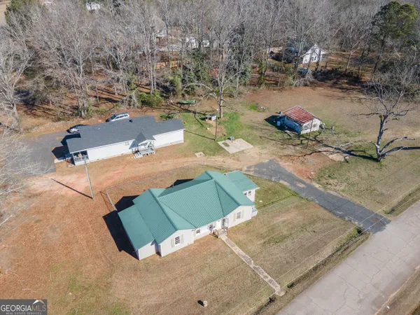 an aerial view of a house with a yard