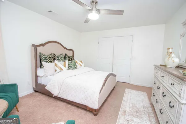 a bedroom with a bed and a dresser