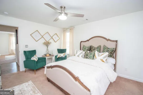 a bedroom with a bed mirror and a window