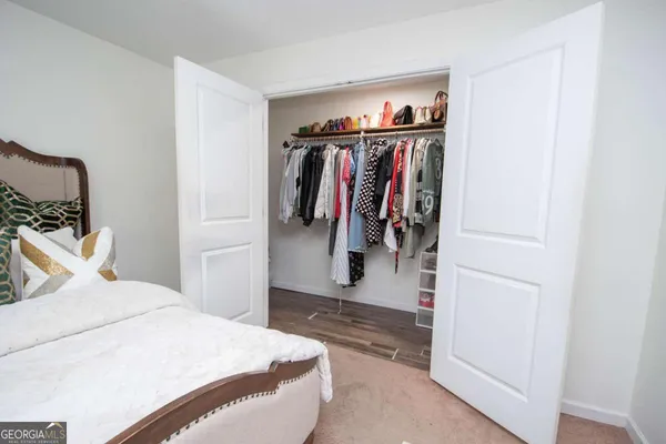 a bedroom with a bed and a walk in closet