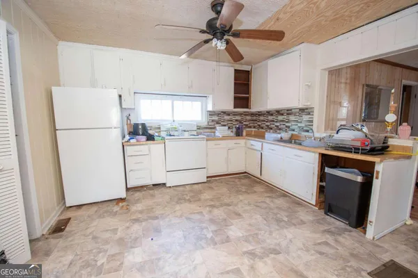 a kitchen with a stove a refrigerator and a sink