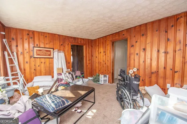 a living room with furniture a large window and a rug