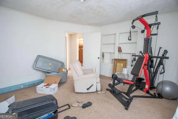 a bedroom with furniture and a gym equipment