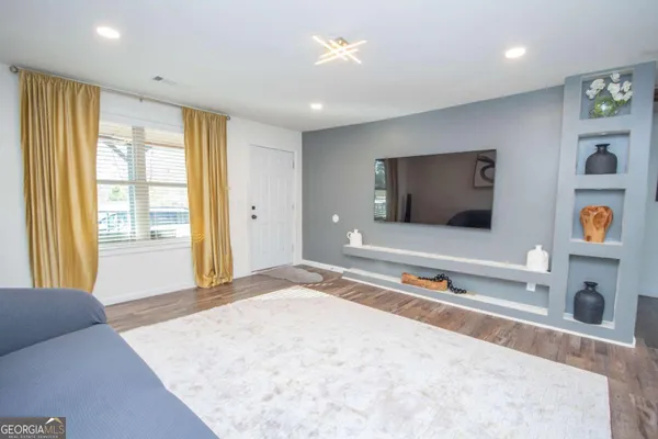a living room with a flat screen tv and a couch