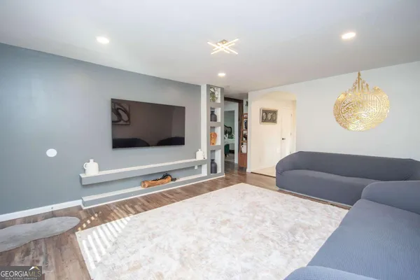 a living room with furniture and a flat screen tv