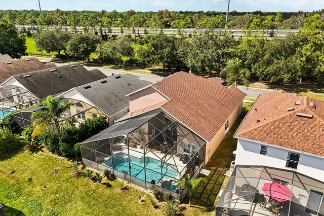 an aerial view of residential houses with outdoor space and street view