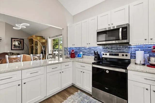 a kitchen with cabinets appliances and a sink