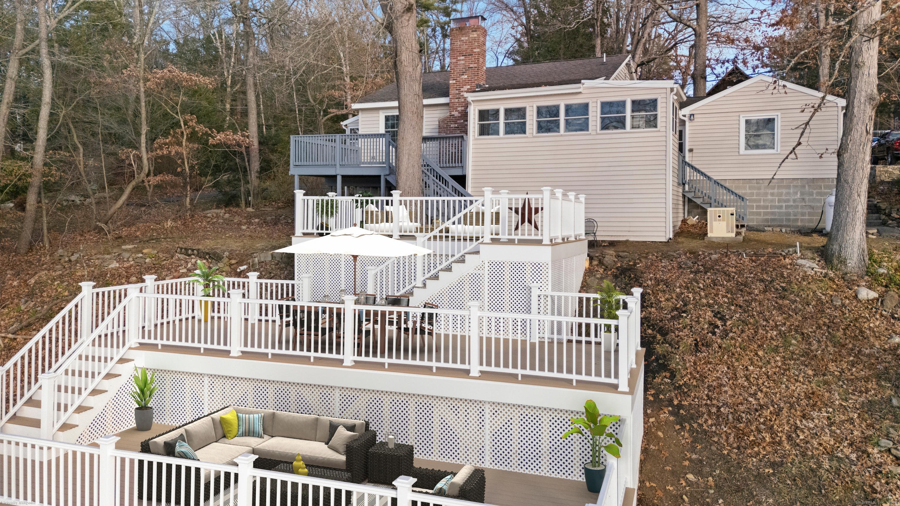 a view of a house with a wooden deck
