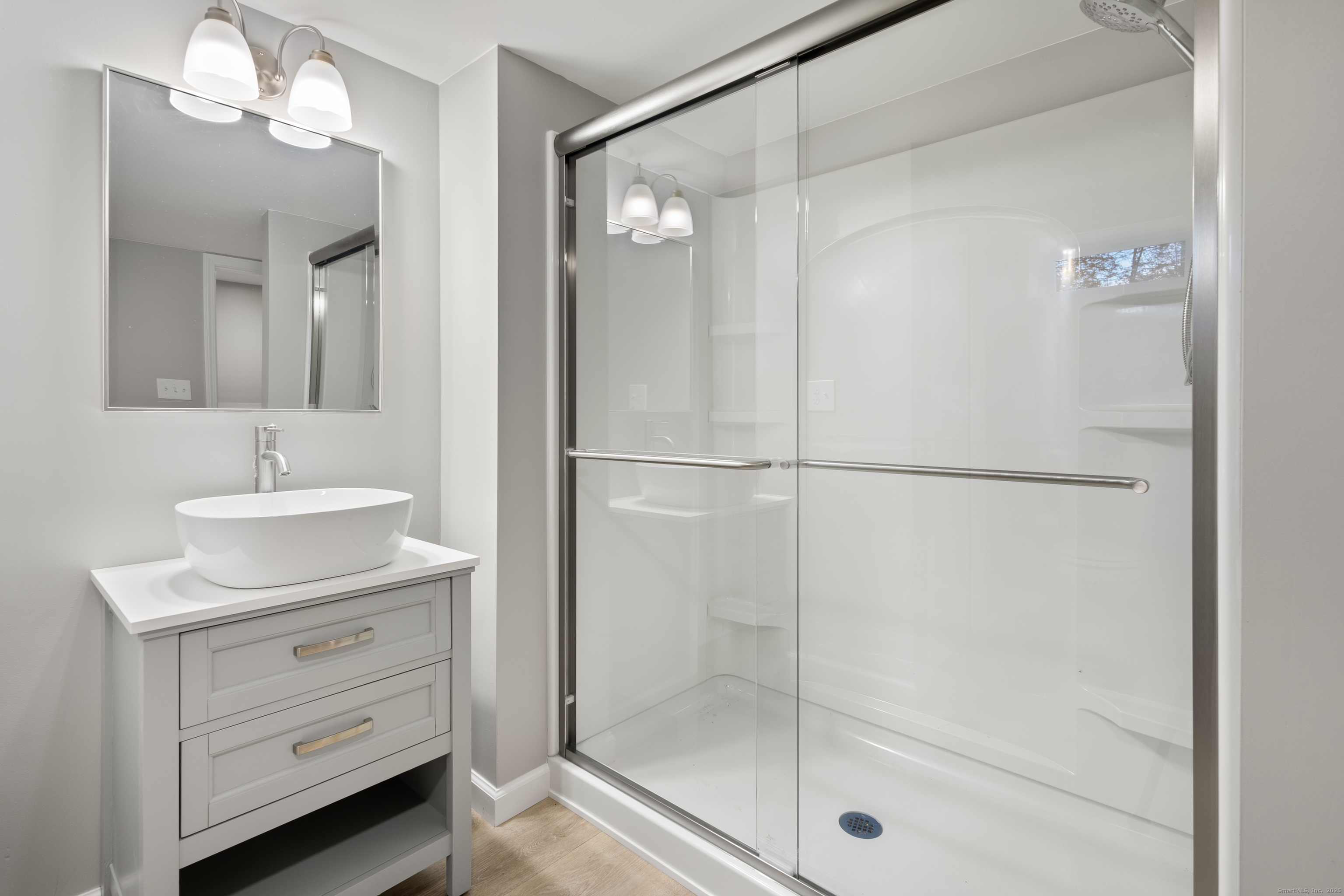 60 Indian Spring Road Woodstock, CT 06282 - Photo 24 of 32 a bathroom with a shower sink and mirror