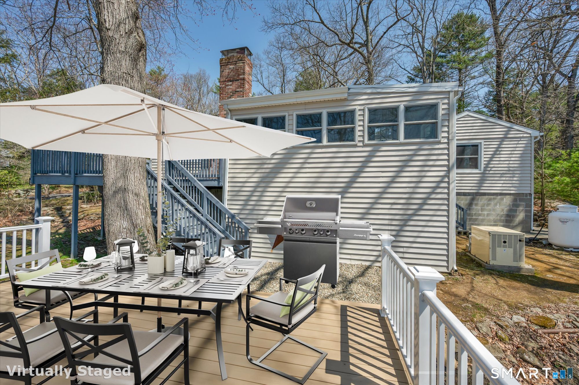 60 Indian Spring Road Woodstock, CT 06281 - Photo 8 of 40 a view of a patio with table and chairs under an umbrella