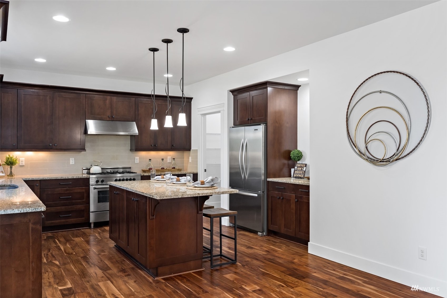 1012 North 29th Street Renton, WA 98056 - Photo 11 of 40 a kitchen with stainless steel appliances granite countertop a stove a sink dishwasher and a refrigerator with wooden floor