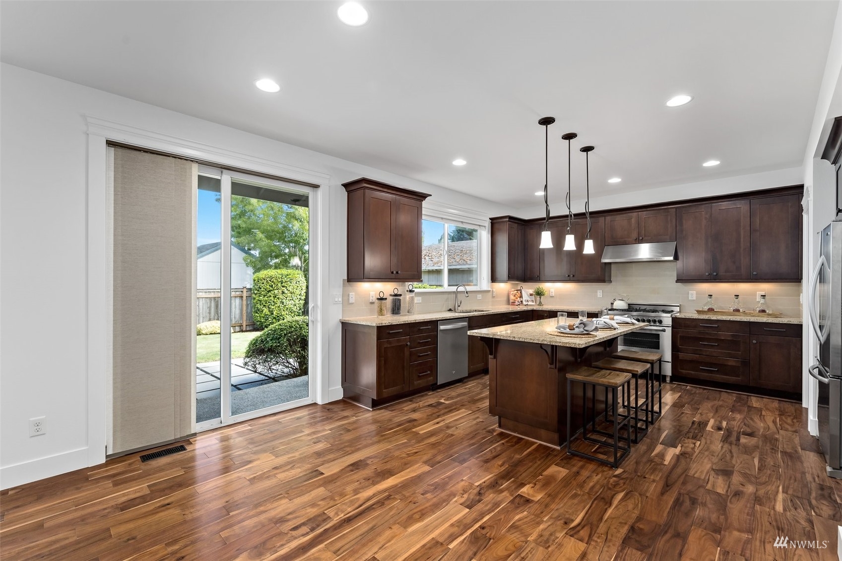 1012 North 29th Street Renton, WA 98056 - Photo 12 of 40 a kitchen with stainless steel appliances granite countertop a stove a sink and a refrigerator